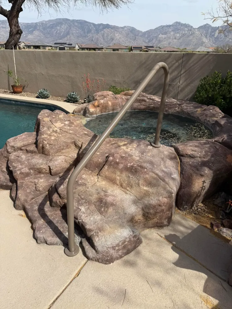 New pool handrail installed on a rock spa in Tucson