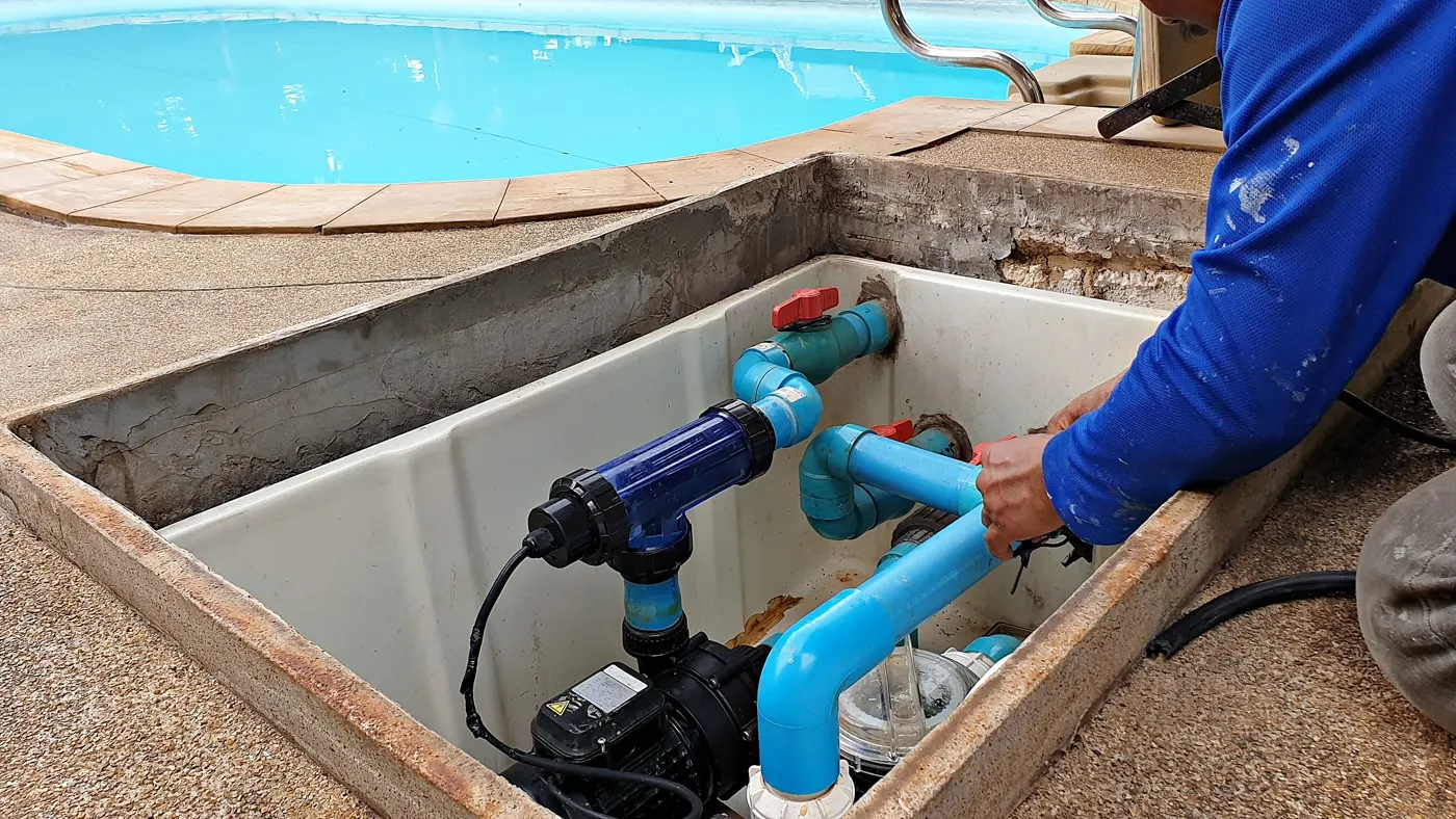 Alex working on pool pump plumbing at a Tucson equipment pad