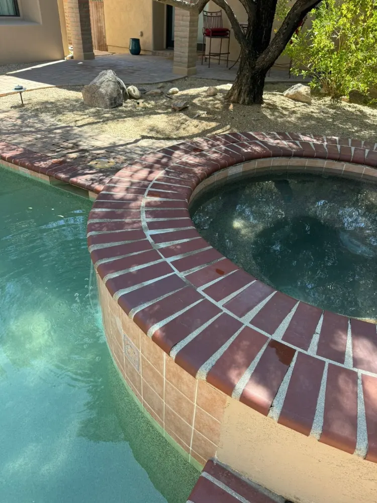 Spa edge with new tile and coping after repair by Blue Dolphin Pools