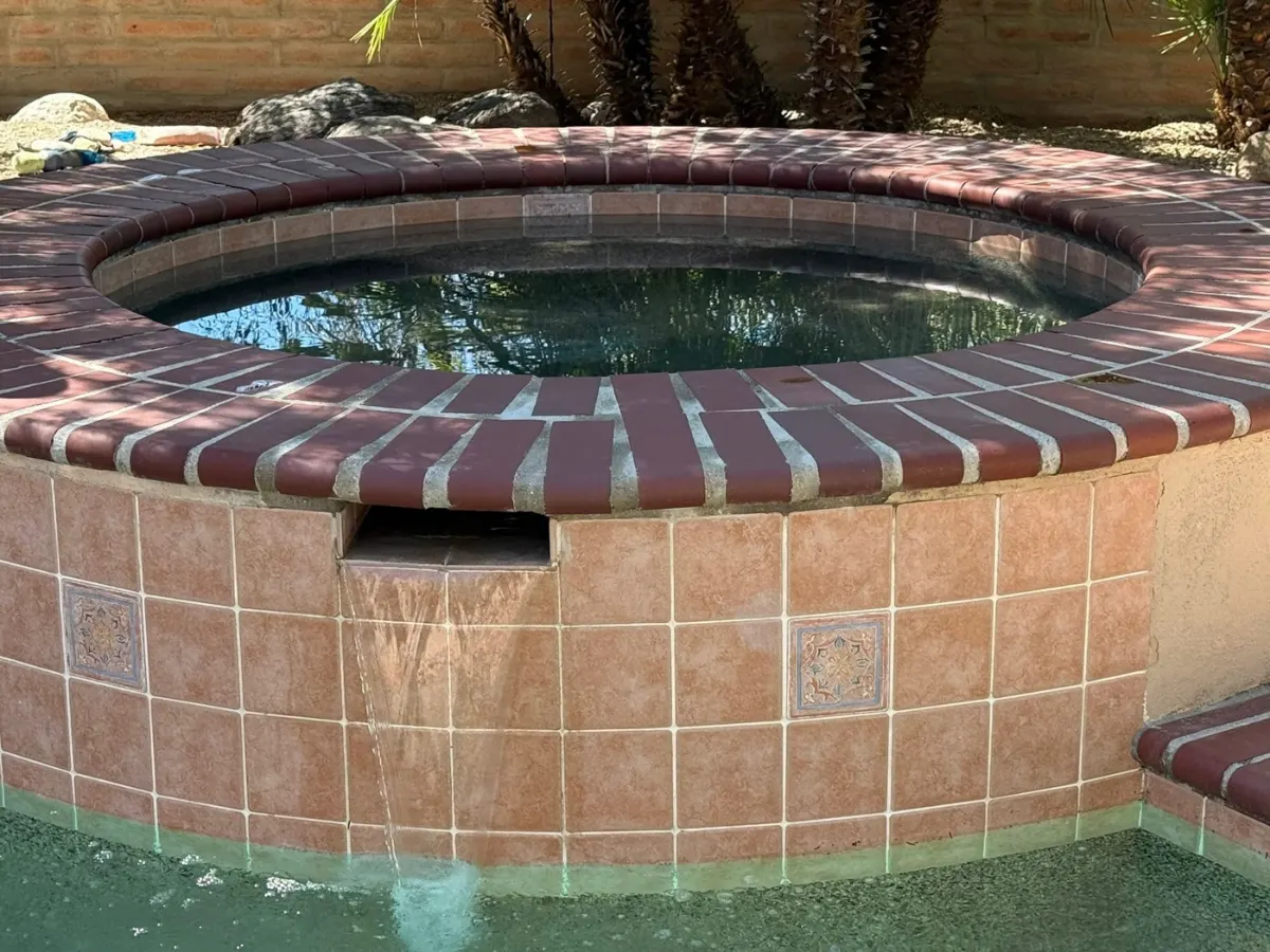 Spa tile and spillway restored after cleaning by Blue Dolphin Pools